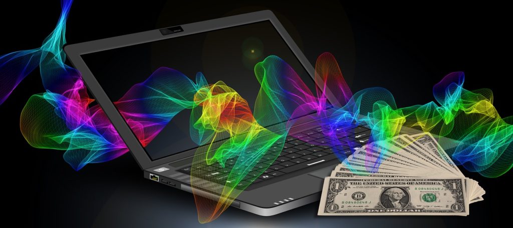 Ноутбук, доллары и разноцветная лента